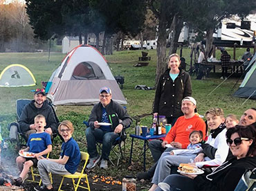 Group of family and friends camping next to Lake Fork having fun