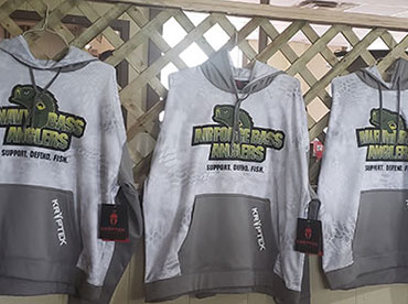 Three long-sleeved, fishing sweatshirts are displayed on hangers